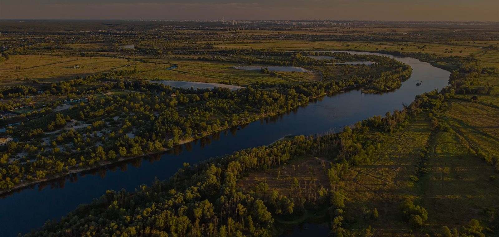 Wide river bending through green Louisiana meadows